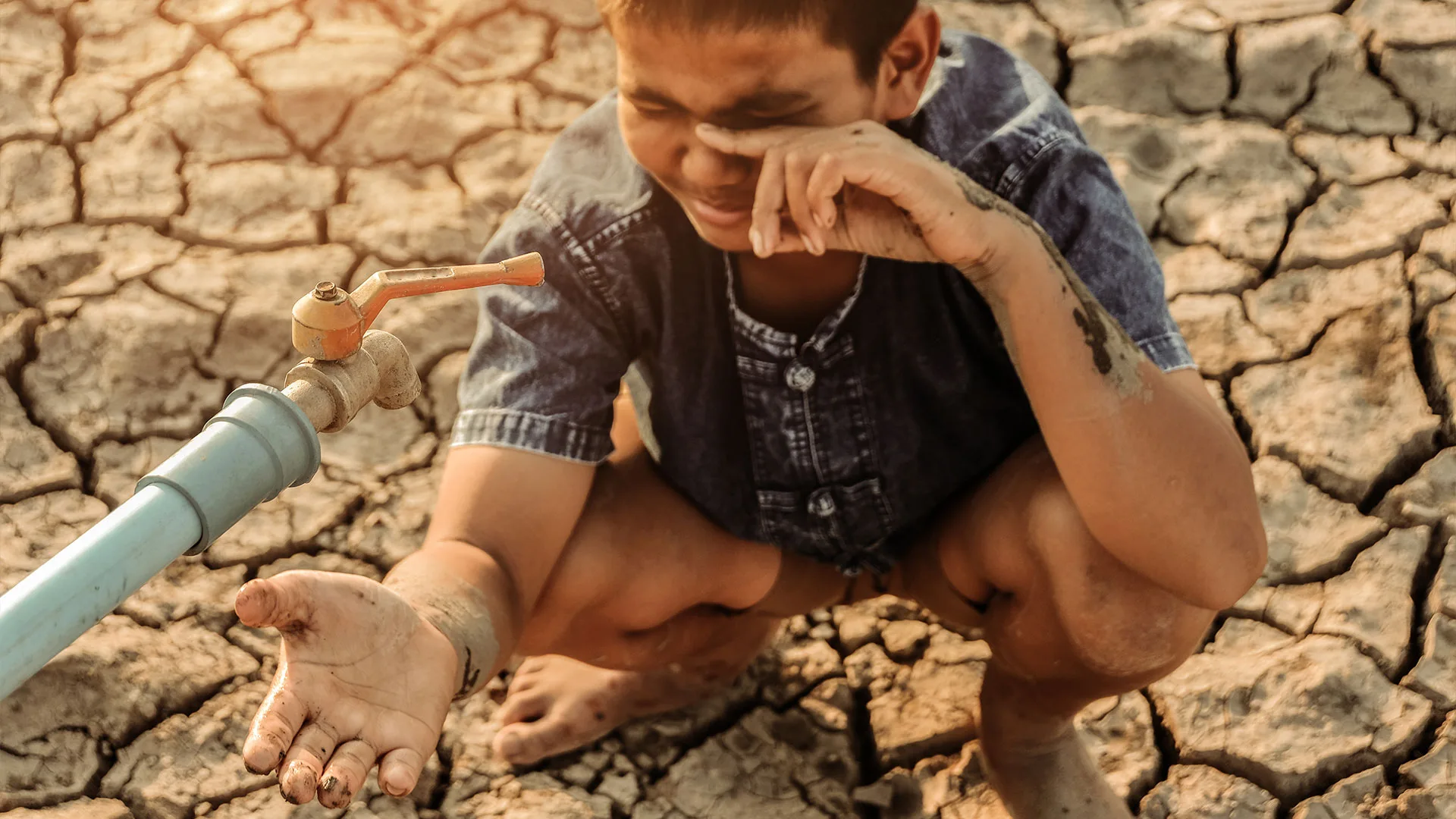 Child and Drought: Desperate for Water on Cracked Earth